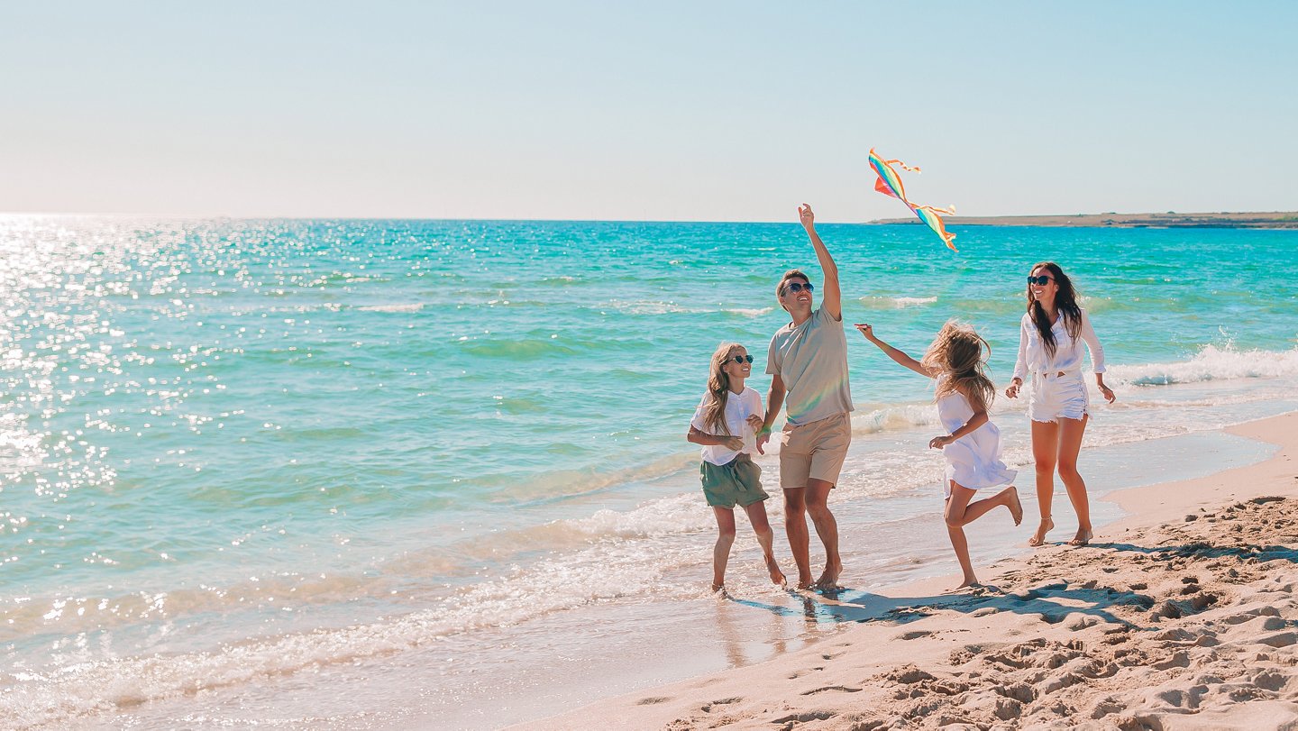 Familie am Strand lässt Drachen steigen