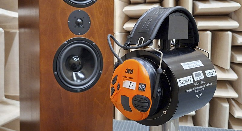 Akustische Prüfvorrichtung mit Kapselgehörschutz auf einem Stativ im schallisolierten Messlabor