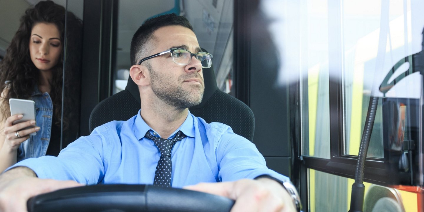 A bus driver behind the wheel
